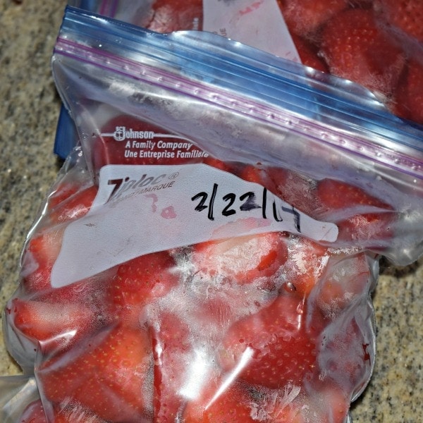 Red frozen strawberries in a Ziploc Bag