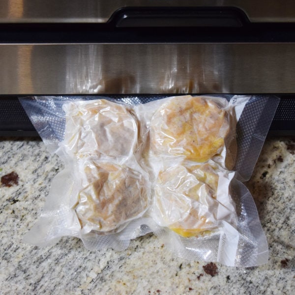 egg muffins being sealed with a food saver for bulk freezer meal prepping