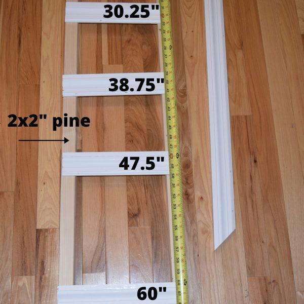 wood pieces on a hardwood floor with measurements on them