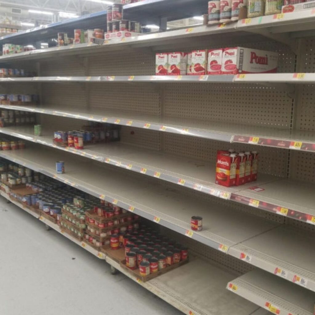 supermarket isle full of empty shelf with food shortages