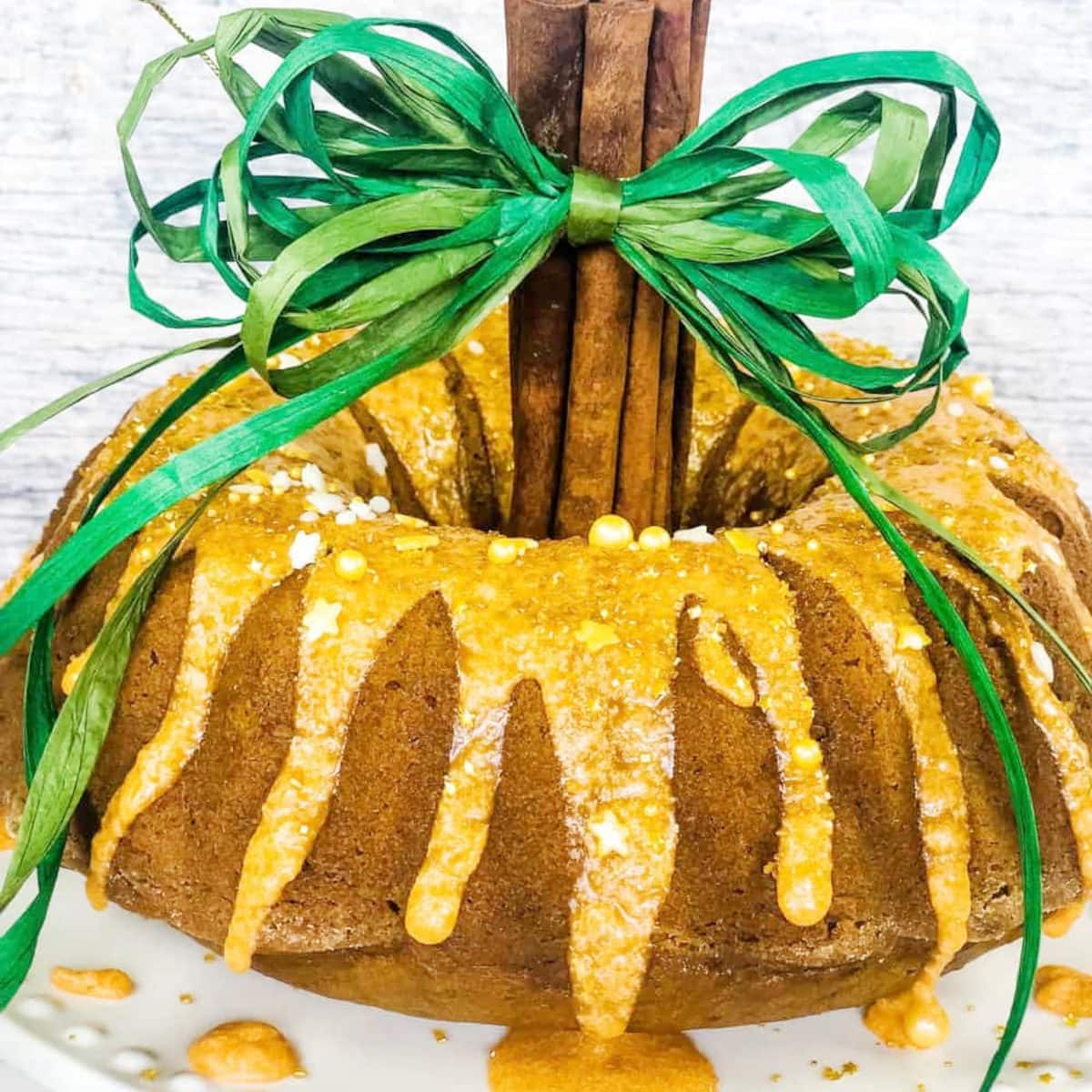 pumpkin bundt cake recipe with cinnamon stick in the center for a pumpkin stem and a green ribbon for a leaf