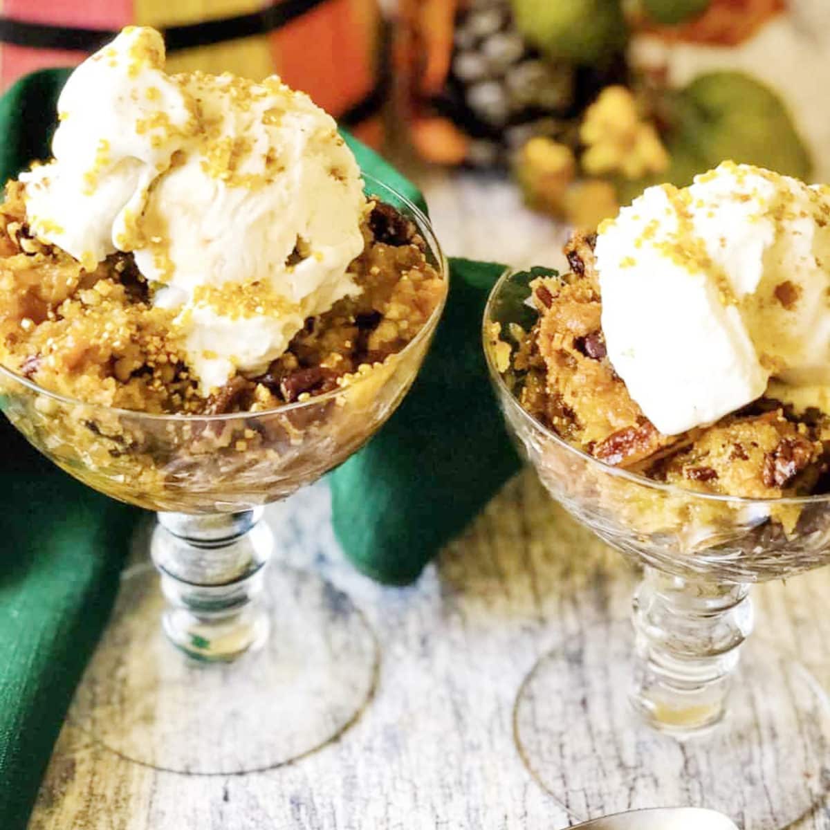 pumpkin dump cake recipe in clear wine glasses topped with cool whip
