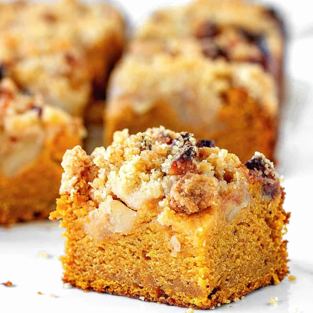 pumpkin dump cake slice on a white surface