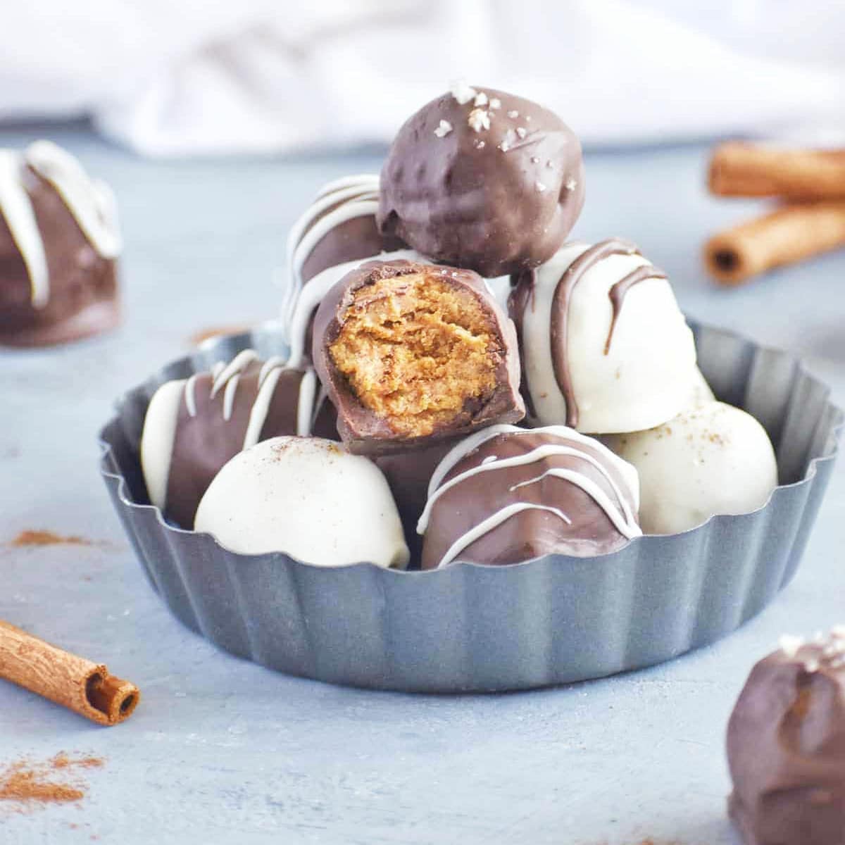 pumpkin cake balls stacked high in a metal pan