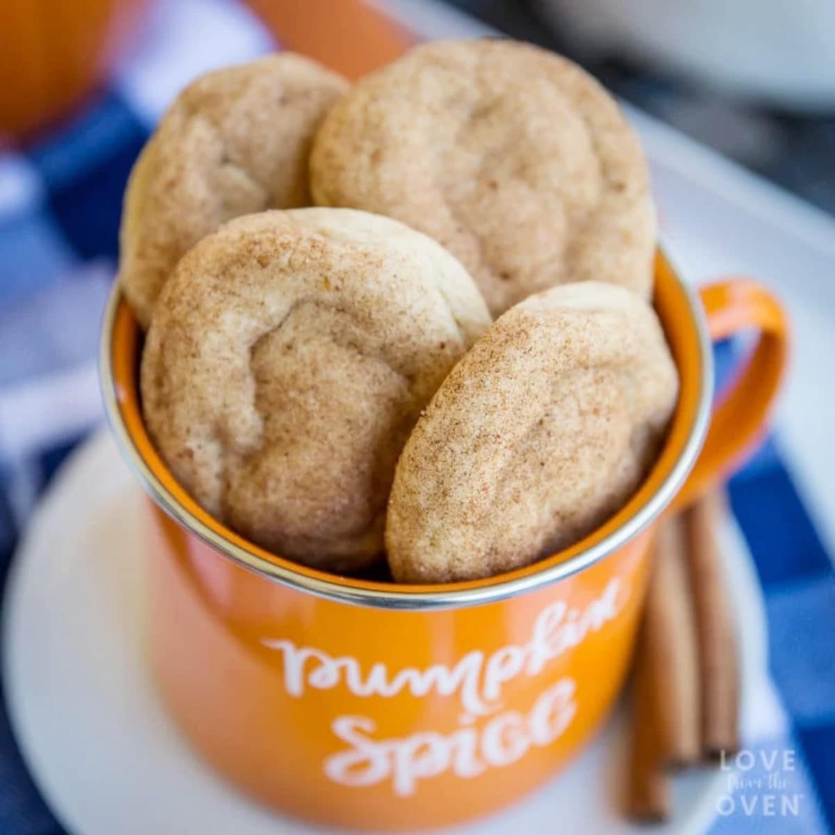 4 tasty pumpkin cookies displayed in an orange mug