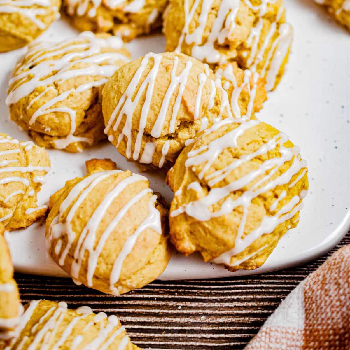 10 pumpkin sourdough cookies laying on a white plate